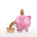 Golden,Coins,Falling,Into,A,Pink,Piggy,Bank,,Isolated,On